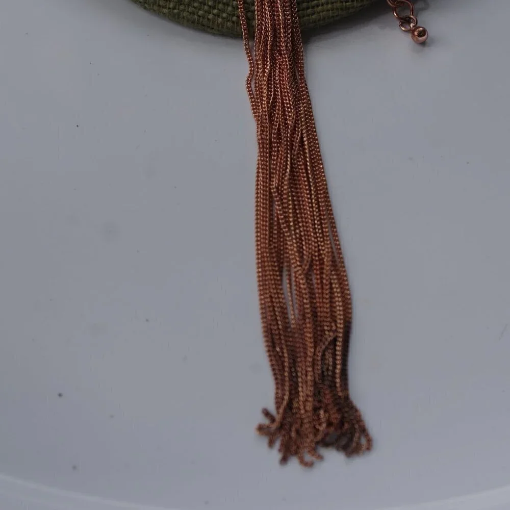 Women`s copper colored long tassel necklace.
